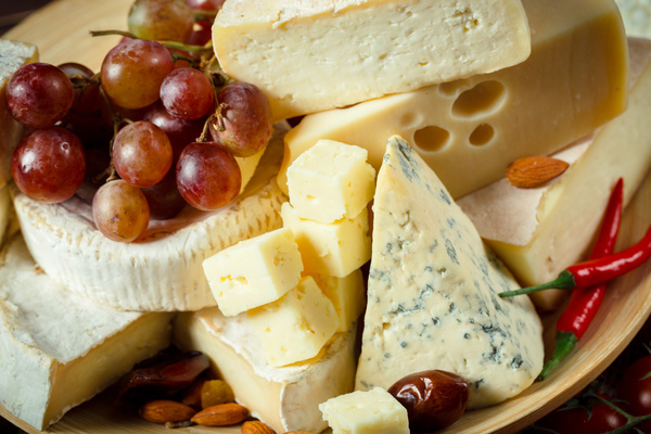 Different sorts of cheese on wooden table Stock Photo 05
