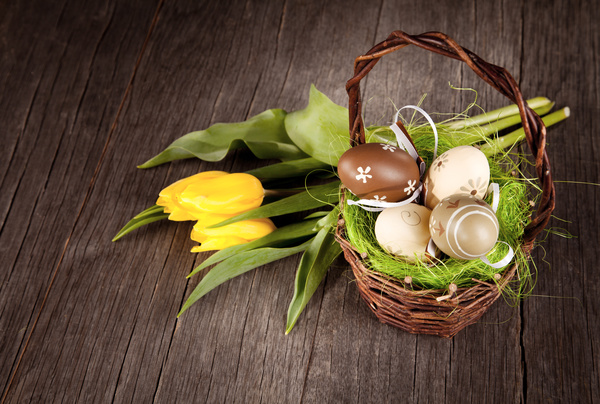 Easter eggs and flowers in the desktop basket Stock Photo 01