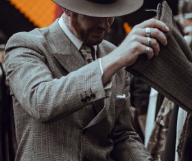 Elegant man selecting clothes in shop Stock Photo