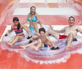 Family playing water slides Stock Photo