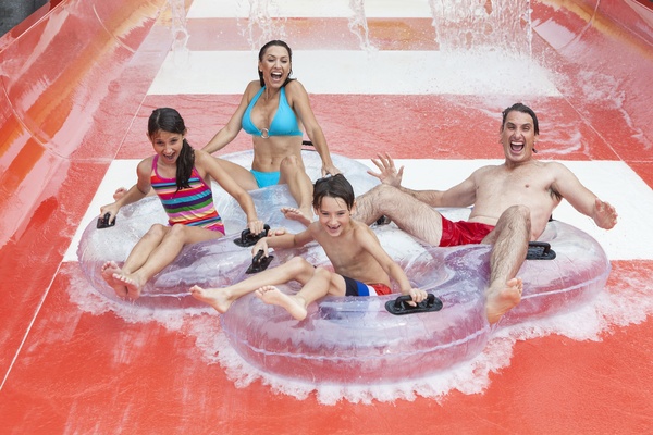 Family playing water slides Stock Photo