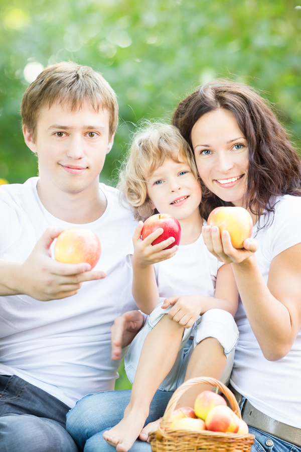 Family with fruit in hand Stock Photo