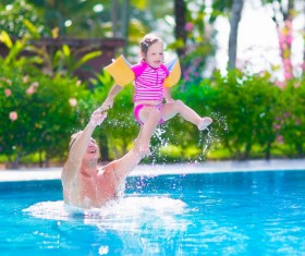 Father and daughter play in the water Stock Photo