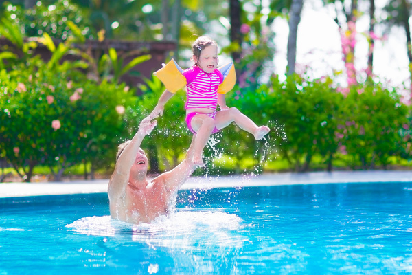 Father and daughter play in the water Stock Photo