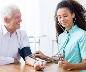 Female nurses give blood pressure elderly Stock Photo