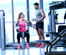 Fitness trainer talking to female trainee Stock Photo