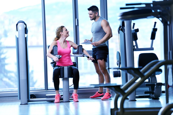 Fitness trainer talking to female trainee Stock Photo