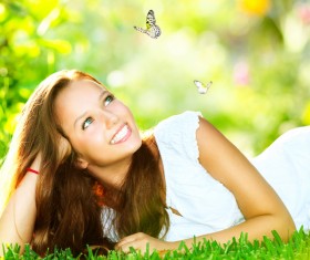Girl and butterfly lying on the grass Art photography Stock Photo