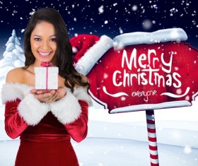 Girl holding Christmas gift and wooden sign Stock Photo