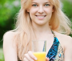 Girl holding a glass of orange juice Stock Photo