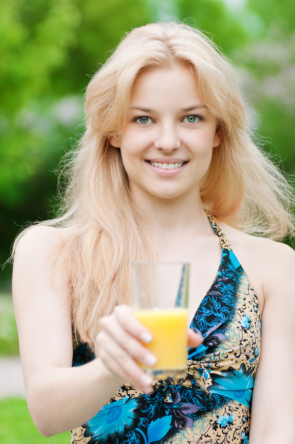 Girl holding a glass of orange juice Stock Photo