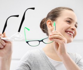 Girl holding glasses of myopia Stock Photo