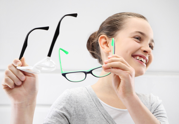 Girl holding glasses of myopia Stock Photo