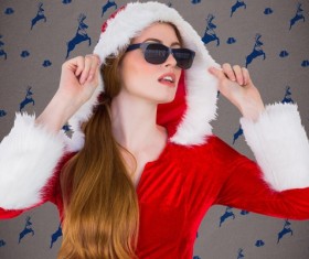 Girl wearing sunglasses wearing Christmas dress Stock Photo
