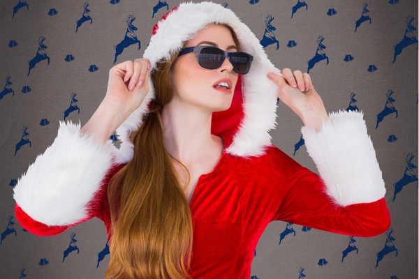 Girl wearing sunglasses wearing Christmas dress Stock Photo