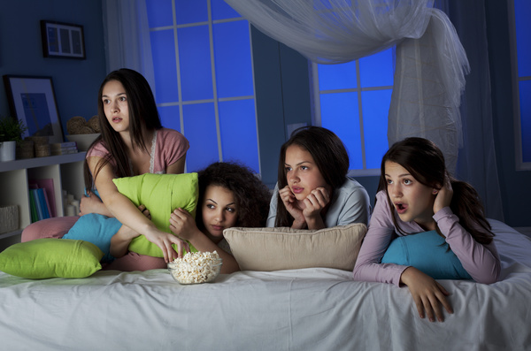 Girls gathered together watching TV Stock Photo