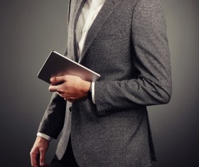 Handsome young man in business suit holding tablet PC Stock Photo 02