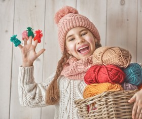 Happy little girl holding knitwear Stock Photo 01