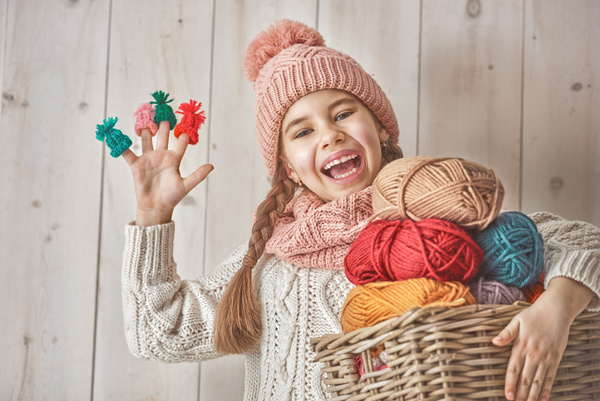 Happy little girl holding knitwear Stock Photo 01