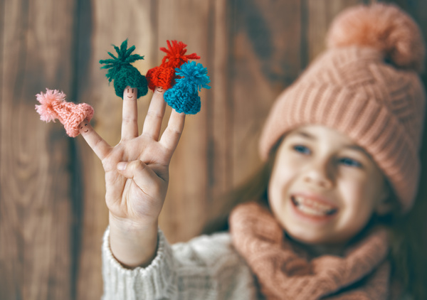Happy little girl holding knitwear Stock Photo 02