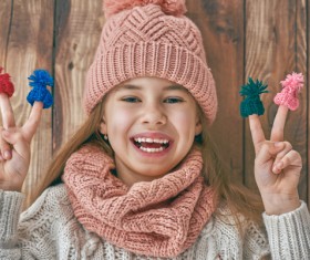 Happy little girl holding knitwear Stock Photo 03