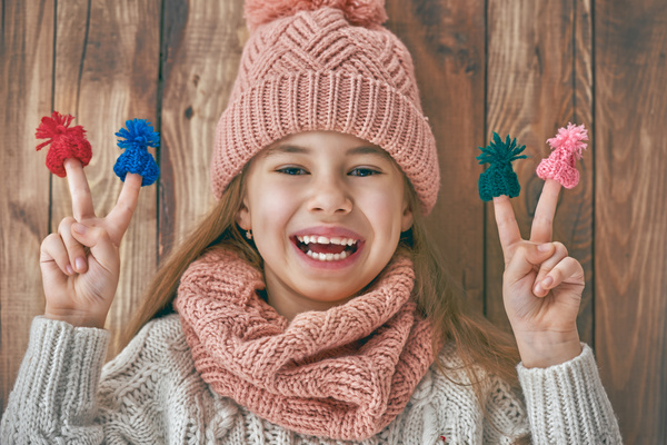 Happy little girl holding knitwear Stock Photo 03