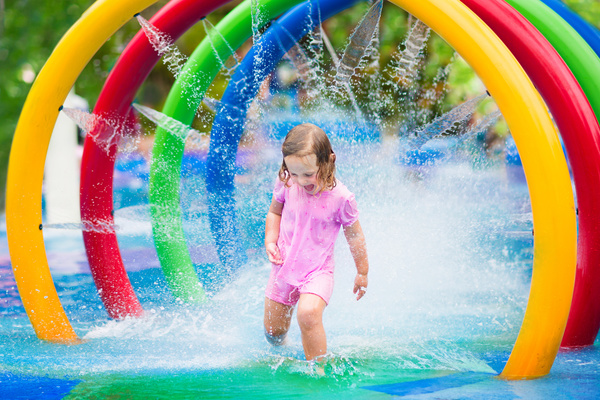 Happy little girl playing in water amusement park Stock Photo 06