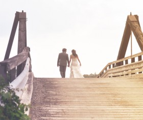Happy marriage couple walking on ancient bridge Stock Photo