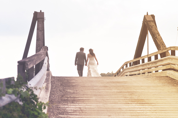 Happy marriage couple walking on ancient bridge Stock Photo