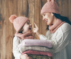 Happy mother and daughter wearing knitted sweaters Stock Photo