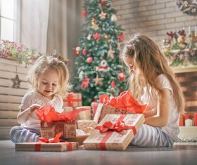 Happy sisters disassemble gift Stock Photo