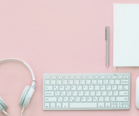 Headphone keyboard on pink desktop Stock Photo