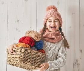 Holding the little girl with a basket of wool Stock Photo