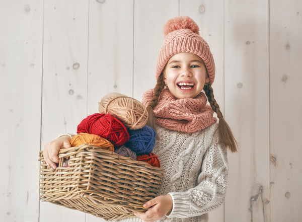Holding the little girl with a basket of wool Stock Photo