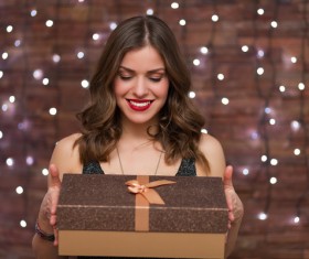 Holiday lantern and woman holding gift Stock Photo