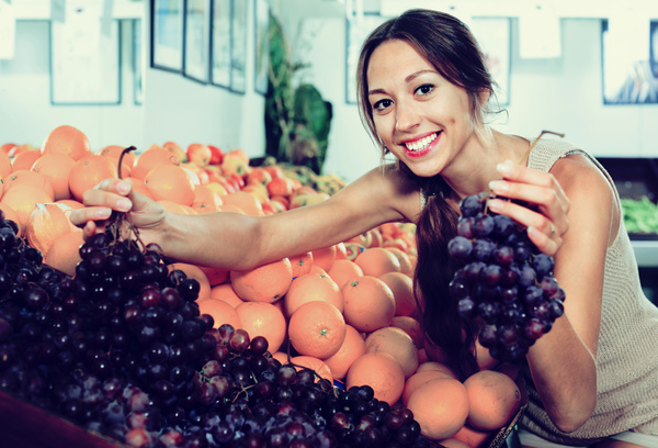 Housewife buy grapes Stock Photo