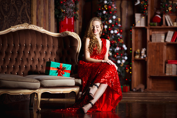 Lady in red dress sitting on sofa Stock Photo 02