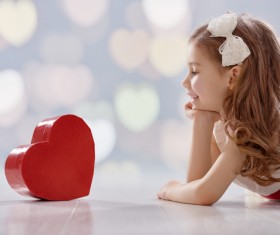 Little girl looking at heart box Stock Photo
