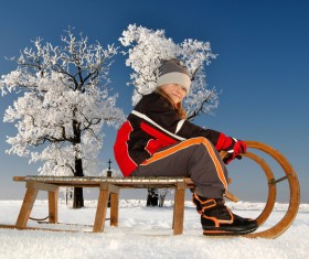 Little girl playing sledge Stock Photo