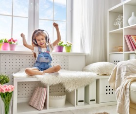 Little girl waving his arms while listening to music Stock Photo