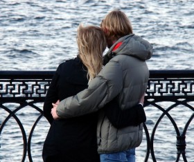 Lovers hugging each other on the bridge Stock Photo