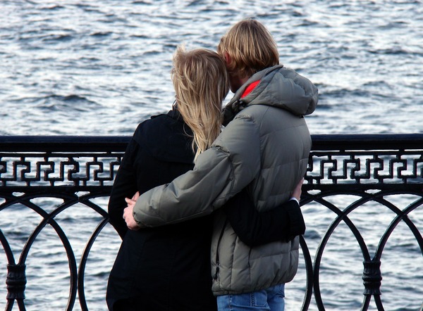 Lovers hugging each other on the bridge Stock Photo