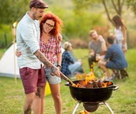 Lovers standing by the campfire Stock Photo