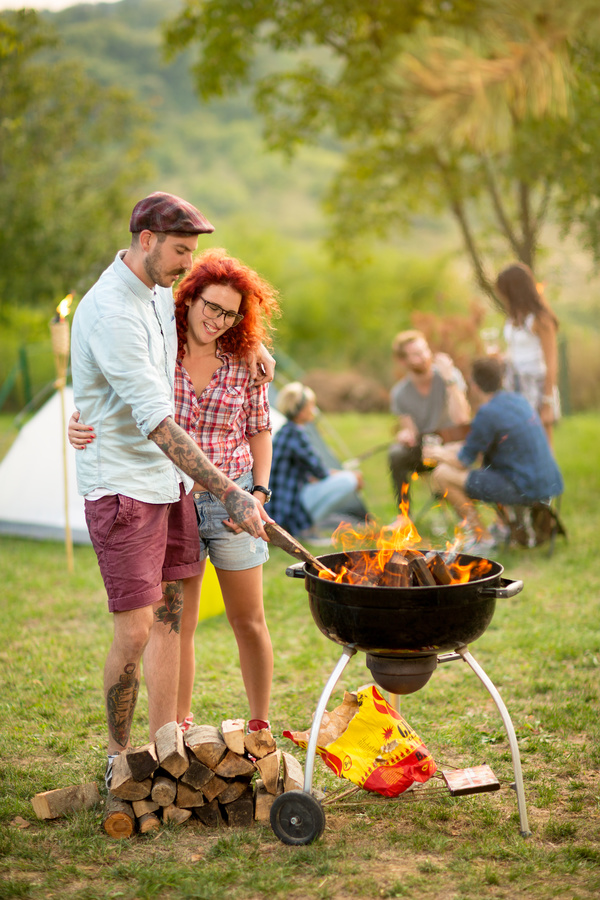 Lovers standing by the campfire Stock Photo