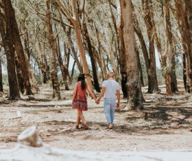 Lovers walking in the woods Stock Photo
