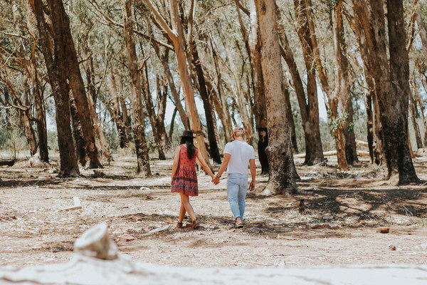 Lovers walking in the woods Stock Photo