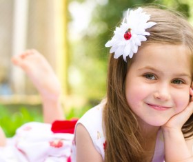 Lying on the grass cute little girl Stock Photo