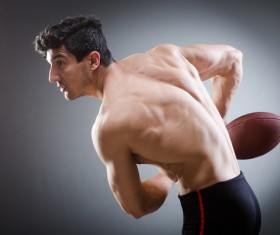 Man holding rugby ball Stock Photo