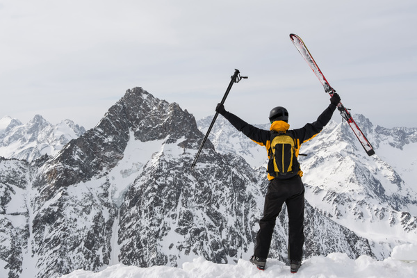 Man holding up ski equipment Stock Photo