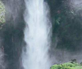 Man in front of beautiful waterfall Stock Photo